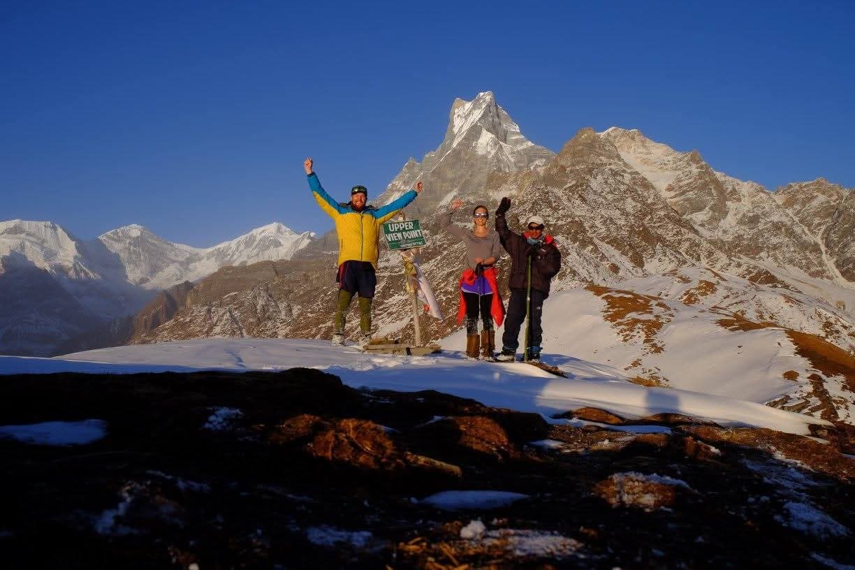 Trekkers celebrate at Upper View Point overlooking Machapuchare and Annapurna