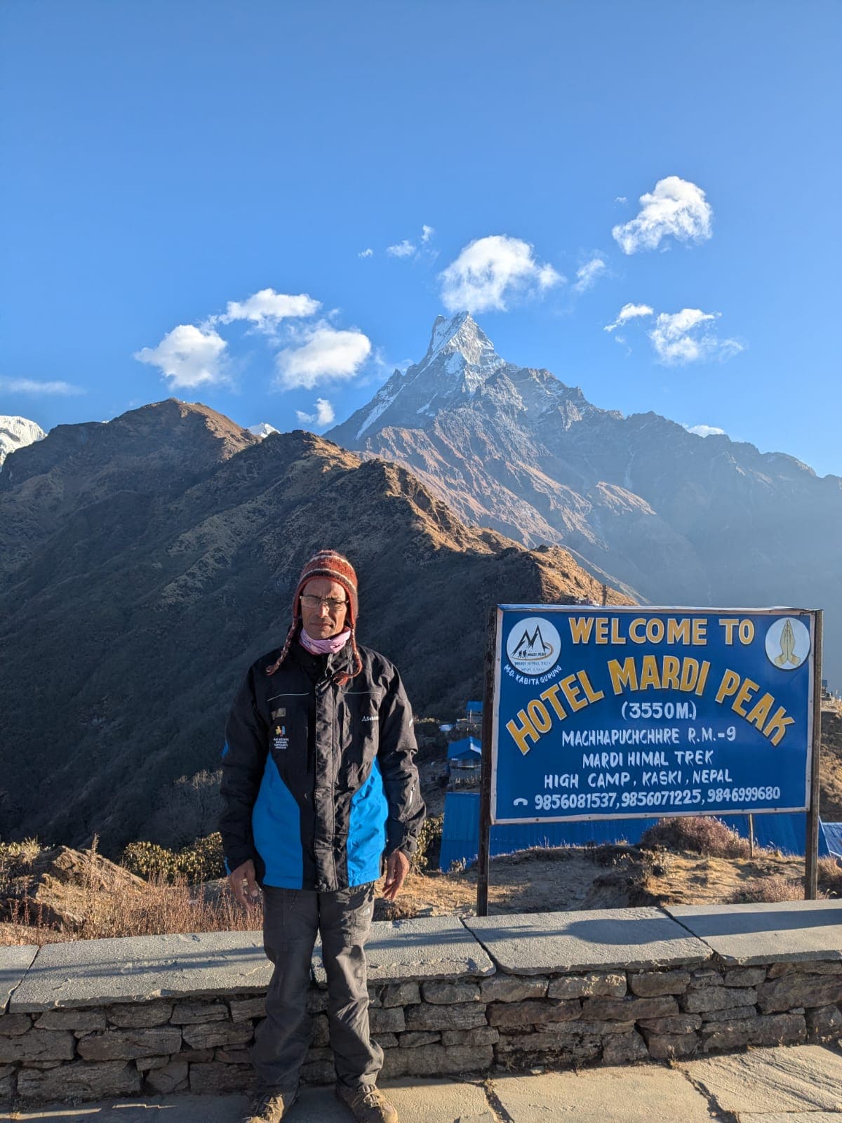 Hiker at Mardi Peak with Machhapuchhre mountain backdrop on Mardi Himal Trek