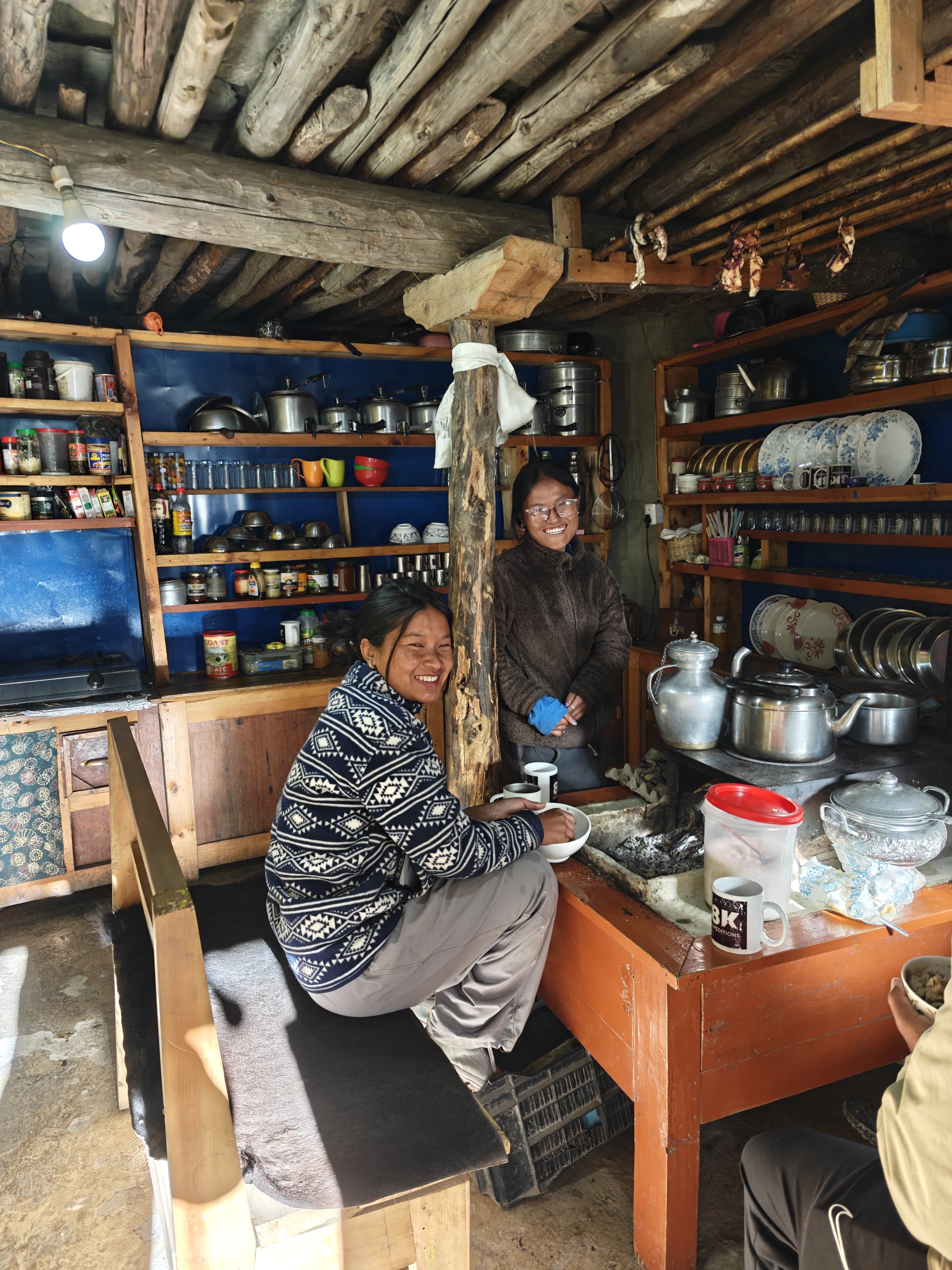 Smiling women in a rustic village kitchen with wooden beams