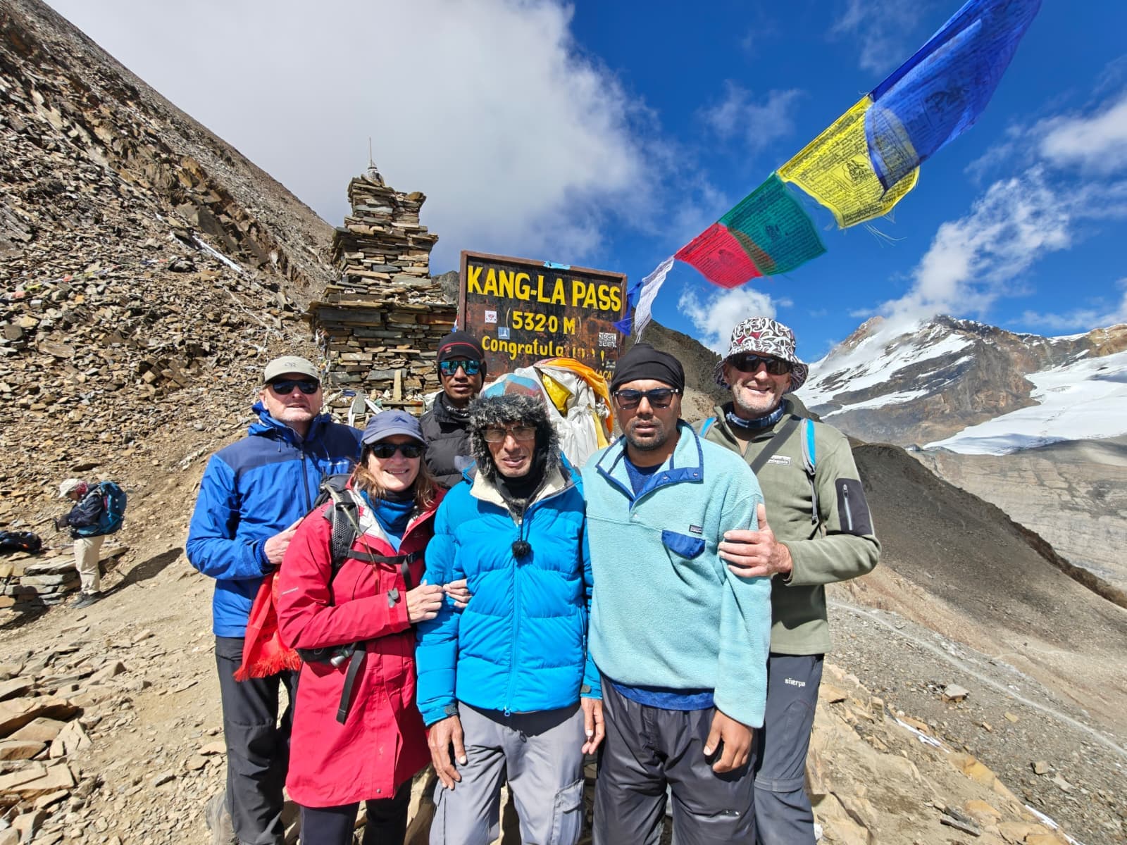 Trekkers at Kang-La Pass (5320m) in Annapurna Himalayas with prayer flags